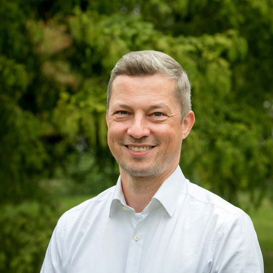 Portrait von Matthias Kortmann vor grünem Hintergrund
